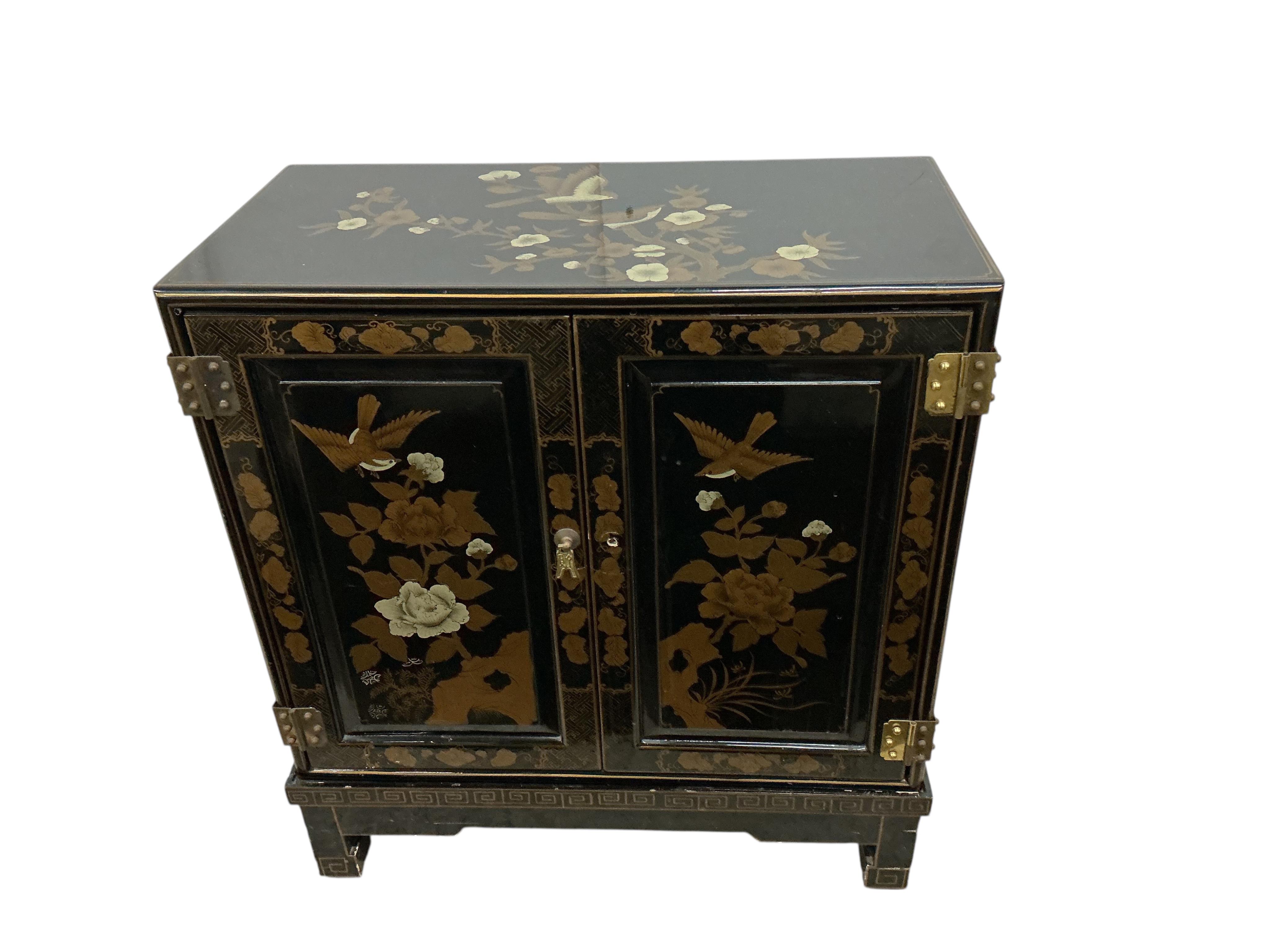 A small Chinese lacquered side cabinet, width 61cm, depth 30cm, height 67cm